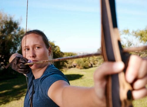 a woman archer holding her bow